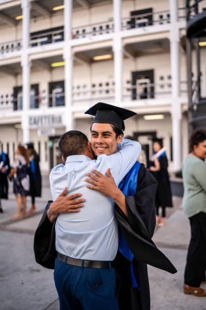 istock Young graduate man embracing his father on the graduation 1496192426