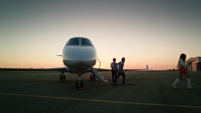Passengers Leaving Private Jet at Sunset - Aerial