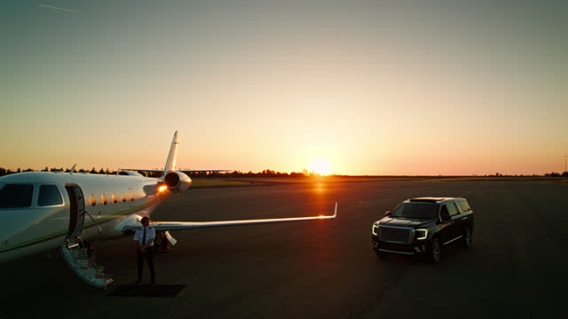 Black Luxury SUV on Runway Next to Private Jet