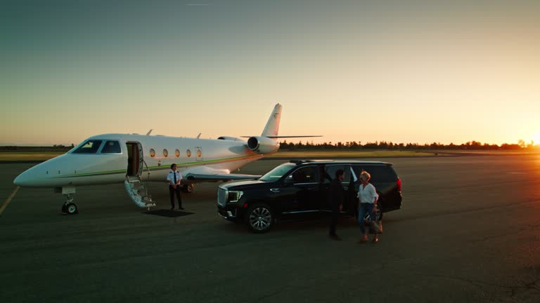 Woman Wearing White Shirt Exits a Black Luxury SUV Parked Near a Private Jet