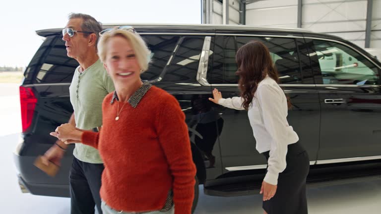 Air Hostess Opens Luxury SUV Door For Mature Sophisticated Couple In an Airplane Hangar