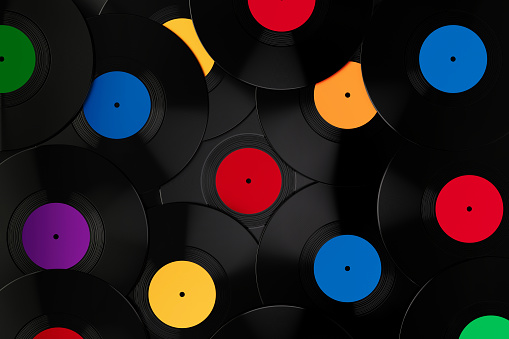 Vinyl records over black background. Horizontal composition with copy space. Vintage music concept.