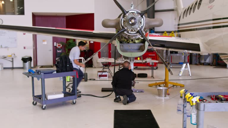 Mechanics Performing Repairs On Private Jet