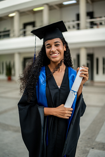 Portrait of young graduate woman on her graduation