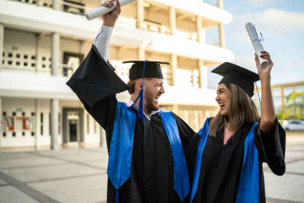 istock Young graduates friends celebrating their graduation 1496195432