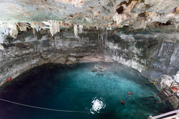 Picturesque sight of the green waters of the X'Canche Cenote, a  natural limestone cavern with a deep natural pool of fresh water near Ek Balam,near Valladolid,Yucatan,Mexico