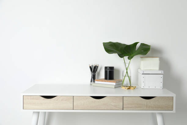 istock Comfortable workplace with white desk near wall. Space for text 1496197386