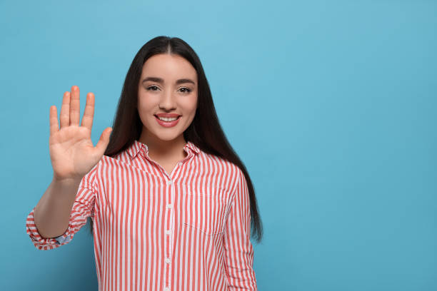 istock Happy woman giving high five on light blue background, space for text 1496198619