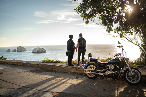 Mature couple relaxing and contemplating on a motorcycle road trip