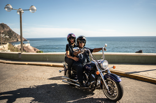 Portrait of mature couple having a road trip on a motorbike
