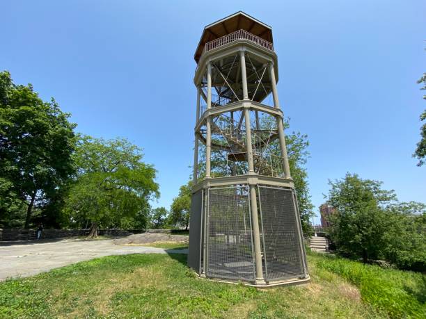 Historic Harlem Fire Watchtower in the Acropolis Plaza on the top of Marcus Garvey Park, Harlem View of the historic cast-iron Harlem Fire Watchtower and its spiral staircase and bell—used to spot fires in the 19th century—in the Acropolis plaza on the top of Marcus Garvey Park in Harlem, New York City harlem park stock pictures, royalty-free photos & images
