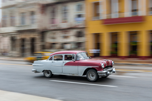 Havana, Cuba - October 21, 2017: Old Car in Havana, Cuba. Panning. Retro Vehicle Usually Using As A Taxi For Local People and Tourist. Red Color