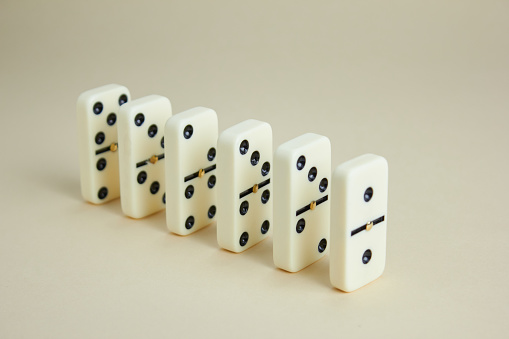 Falling dominoes on table.
