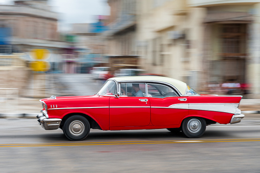 Havana, Cuba - October 21, 2017: Old Car in Havana, Cuba. Retro Vehicle Usually Using As A Taxi For Local People and Tourist. Panning Red Color Car