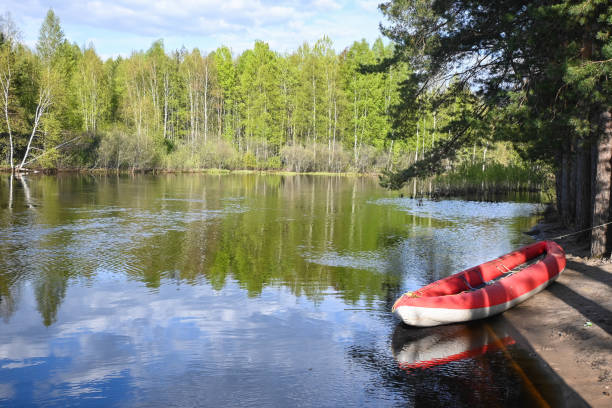 Traveling along the river in a boat. A deserted river landscape with an inflatable kayak.