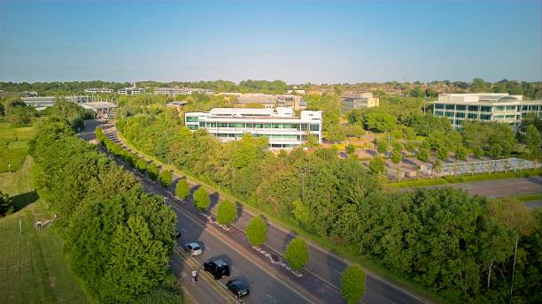 Reading, United Kingdom - A view along the river Thames at Thames Valley Park An aerial view along the Thames river by Thames Valley Park heading into Reading, United Kingdom - 03.06.2023 thames valley stock pictures, royalty-free photos & images