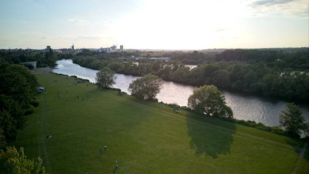 Reading, United Kingdom - A view along the river Thames at Thames Valley Park An aerial view along the Thames river by Thames Valley Park heading into Reading, United Kingdom - 03.06.2023 thames valley stock pictures, royalty-free photos & images