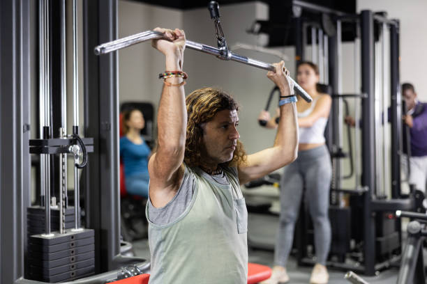 istock Caucasian man is engaged in a simulator for development of back muscles 1496215288