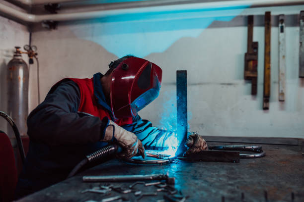 istock Welder erecting technical steel. Industrial steel welder in factory technical 1496215366