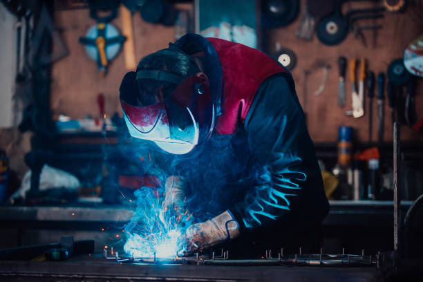 istock Welder erecting technical steel. Industrial steel welder in factory technical 1496219172