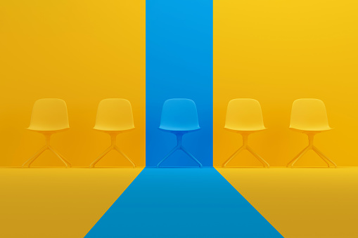 Blue chair that stands out from the crowd of chairs against a yellow studio background. Human resource management concept. 3D render.