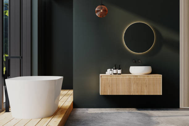 istock Modern bathroom interior with parquet and concrete floor, white sink, round mirror, white bathtub, interior plants, green wall. Minimalist bathroom with modern furniture, forest view. 3D rendering 1496221172