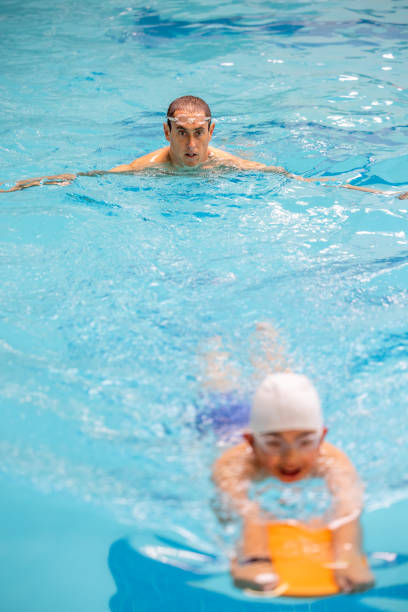 istock Father and Son Swimming and Coaching 1496221850