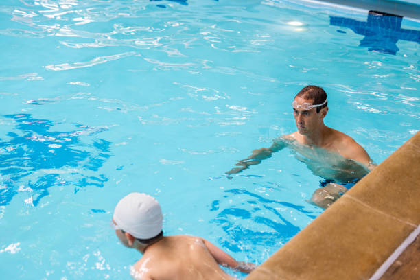 istock Father and Son Swimming and Coaching 1496221883
