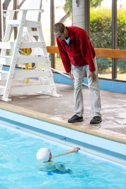 istock Father and Son Swimming and Coaching 1496221972