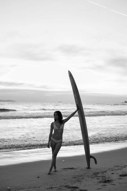 istock Surfer Girl Sunset Black and White 1496222383