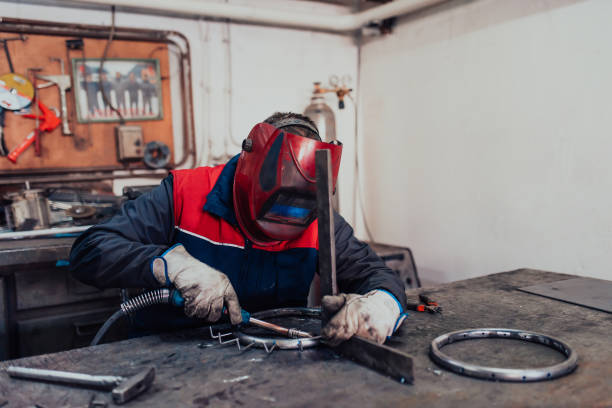 istock Welder erecting technical steel. Industrial steel welder in factory technical 1496223555