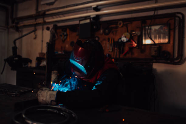 istock Welder erecting technical steel. Industrial steel welder in factory technical 1496224744