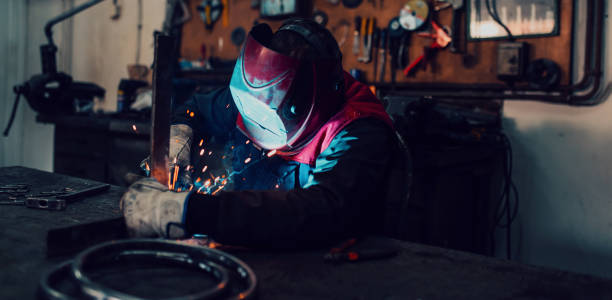 istock Welder erecting technical steel. Industrial steel welder in factory technical 1496224802