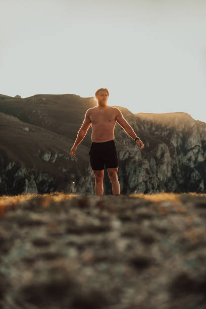 istock An athlete rests on top of a mountain after exhausting running training. 1496231540