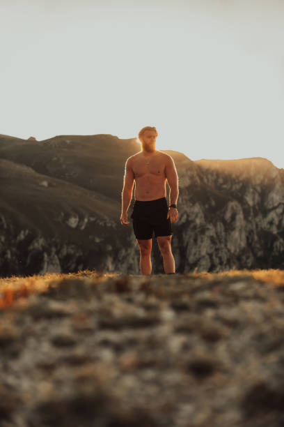 istock An athlete rests on top of a mountain after exhausting running training. 1496231587