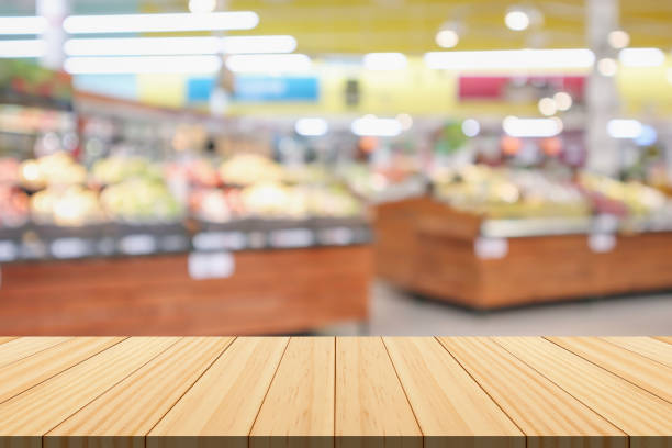 istock Empty wood table top with supermarket blurred background for product display 1496232787