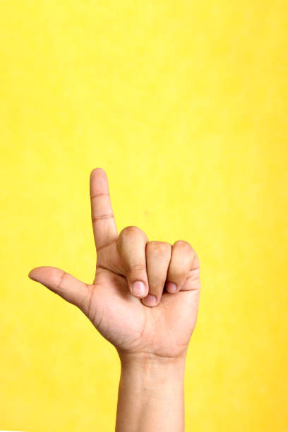 istock Hands of a Latino man makes sign language, expression and gesture-spatial configuration and visual perception with which deaf people establish a channel of communication 1496233541