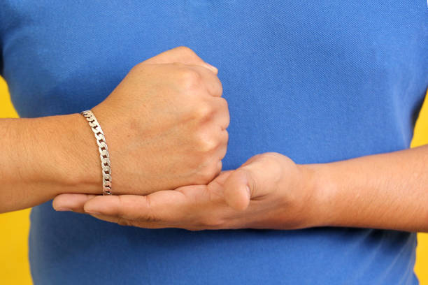 Six people's hands raised on white background.