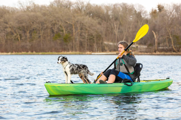 istock Girl & Dog Kayaking on Lake in Springtime 1496237443