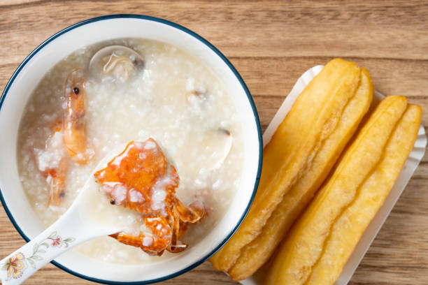 istock top view seafood porridge with crabs and shrimps and white shells and deep-fried dough sticks horizontal composition 1496237700