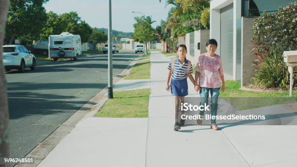 Asian Senior Woman Walking Her Primary School Student Granddaughter To School On Sunny Day Active Travel Healthy Lifestyle Stock Photo - Download Image Now
