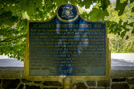 A historical plaque stands on the grounds of St. Andrew's Presbyterian Church (or just the Old Stone Church) in Beaverton, Ontario.
