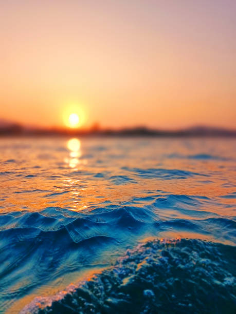 istock Sea wave splash, sunset blurred bokeh background, ocean water surf ripple texture, sunrise soft focus, tropical island beach dawn, sundown orange sun shine reflection, summer holiday, vacation, travel 1496257797