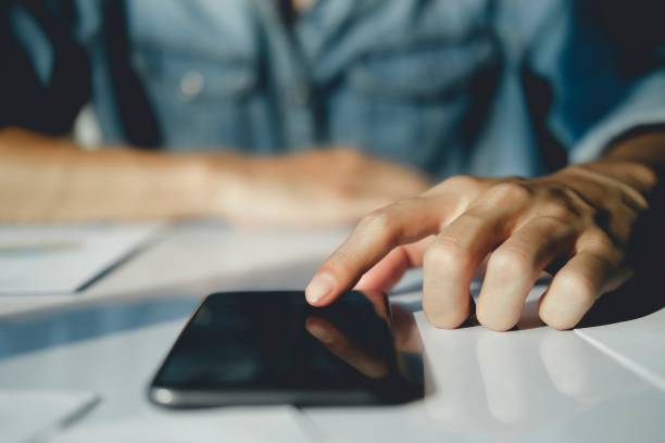 istock Close-up image of male hands using smartphone. 1496260400