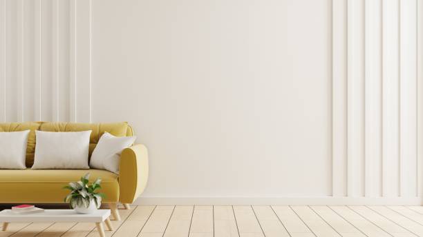 istock White wall interior living room featuring a striking yellow sofa and minimal decoration. 1496261430