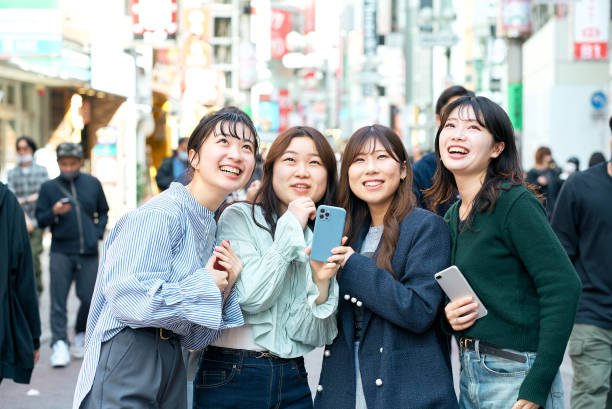 istock Young women using smartphones in the city 1496266559