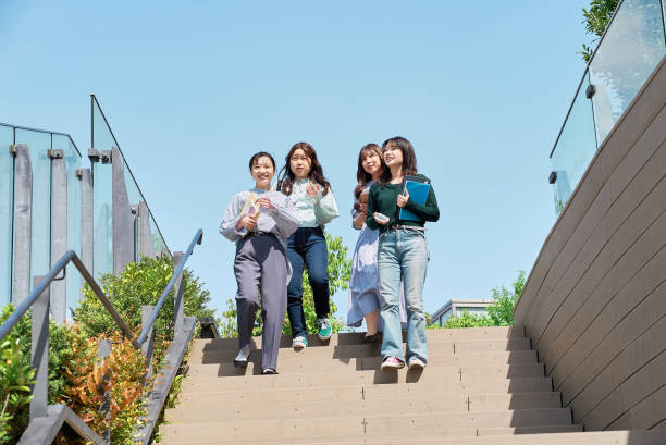 istock Four young women walking together 1496267588