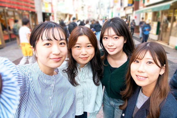 cuatro mujeres jóvenes tomándose selfies en la ciudad - autorretrato fotografías e imágenes de stock