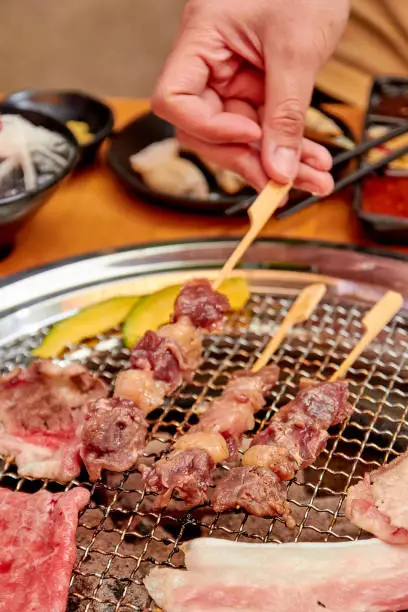 Photo of Beef dry aged skewers. Grilled meat on the grill stove.