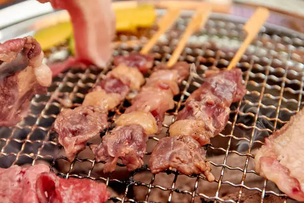 Photo of Beef dry aged skewers. Grilled meat on the grill stove.